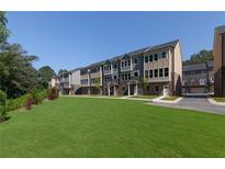 Row of new townhouses with stone and siding accents, lush landscaping, and ample green space at 3794 Jack Vernon Cir, Powder Springs, GA 30127