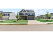 Two-story home with gray siding, brick accents, and a two-car garage at 300 Foxglove Way, Mcdonough, GA 30253