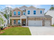 Two-story home with stone accents and a three-car garage at 715 Crossroad Ct, Powder Springs, GA 30127