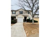 Two-story townhome with attached garage and manicured lawn at 522 Rendezvous Rd, Acworth, GA 30102