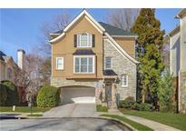 Stunning two-story home with stone accents and a landscaped yard at 1106 Fairway Ne Gdns, Atlanta, GA 30319