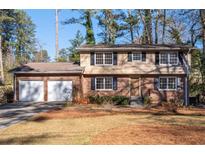Brick house with two-car garage and landscaped yard at 4132 Rue Saint Germain, Stone Mountain, GA 30083
