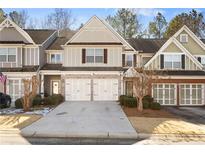 Attractive townhome with three-car garage and well-manicured landscaping at 216 Parc View Ln, Woodstock, GA 30188