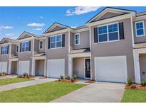 Modern taupe townhouses with attached garages and landscaping at 2278 Jamin Bnd # 17, Lithonia, GA 30058