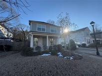 Two-story home with gray siding, brick accents, and a landscaped front yard at 969 Rittenhouse Way, Atlanta, GA 30316