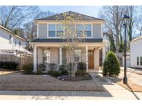 Two-story house with gray siding, brick accents, and a front porch at 969 Rittenhouse Way, Atlanta, GA 30316