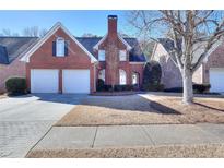 Brick house with two-car garage and manicured lawn at 980 Windsor Place Cir, Grayson, GA 30017