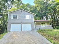 Two-story house with a double garage and a spacious front yard at 4550 Cypress Ridge Ct, Stone Mountain, GA 30083