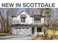 Two-story farmhouse-style home with white siding, gray roof, and attached garage at 3208 Altacrest Dr, Scottdale, GA 30079