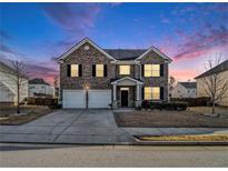 Brick two-story house with a two-car garage and landscaped yard at 2784 Cypress Rdg, Loganville, GA 30052