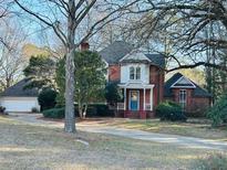 Brick house with wrap around porch and detached garage at 850 Airline Rd, Mcdonough, GA 30252