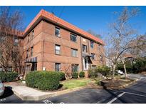 Beautiful three-story brick apartment building with a red tile roof and well-maintained landscaping at 708 Argonne Ne Ave # 5, Atlanta, GA 30308