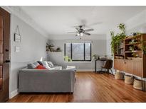 Bright living room features hardwood floors, modern decor, and ample natural light from a large window at 708 Argonne Ne Ave # 5, Atlanta, GA 30308