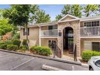 Attractive building exterior with stone accents and landscaping at 2955 Seven Pines Ln # 203, Atlanta, GA 30339