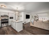Open-concept kitchen with a center island and stainless steel appliances flows into the adjacent living area at 2725 Shoreland Sw Dr, Atlanta, GA 30331