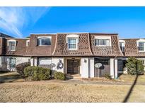 Attractive exterior of a townhouse with brown roof and landscaping at 113 Rue Fontaine # 113, Lithonia, GA 30038