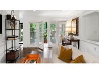 Bright living room with French doors opening to a patio at 311 Peachtree Hills Ne Ave # 15C, Atlanta, GA 30305