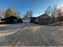 Ranch home with stone accents, attached garage, and RV carport at 208 Hickory Rdg, Cumming, GA 30040