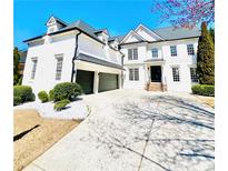 Stunning white two-story home featuring a two-car garage and well-manicured landscaping at 745 Glengate Pl, Atlanta, GA 30328