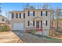 Two-story house with attached garage and landscaped yard at 3731 Cherokee Overlook Dr, Canton, GA 30115