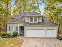 Two-story house with three-car garage and landscaped yard at 2159 Kings Mountain Ne Dr, Conyers, GA 30012