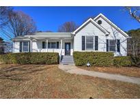 White one-story house with gray roof, landscaping, and walkway at 857 Garner Rd, Rockmart, GA 30153