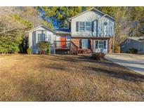 Two-story house with a red door and brown deck at 2522 Corner Shoals Dr, Decatur, GA 30034