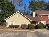Inviting exterior of a charming yellow house with a red brick neighbor at 3754 Sidney Lanier Blvd, Duluth, GA 30096