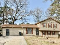 Charming split-level home featuring a well-maintained lawn and classic architectural details at 860 Flat Shoals Rd, Atlanta, GA 30349