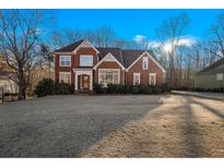 Brick house with a large front yard and mature trees at 2945 Barimore Pl, Dacula, GA 30019