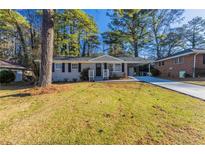 Ranch style home with carport, freshly paved driveway and well manicured lawn at 2230 Star Mist Sw Dr, Atlanta, GA 30311