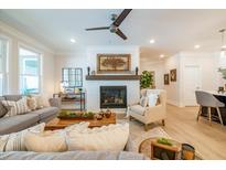 Cozy living room featuring a fireplace and comfortable seating at 112 Redford Ln, Canton, GA 30115