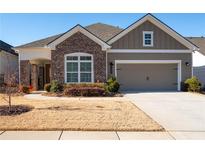 Brick and siding two-story home with attached garage and landscaping at 4980 Pleasantry Nw Way, Acworth, GA 30101