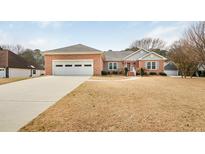 Charming brick home with attached garage, well-maintained lawn, and inviting curb appeal at 1419 Gates Mill Walk, Lawrenceville, GA 30045