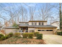 Beautiful home with landscaping and a two-car garage at 3453 Johnson Ferry Ne Rd, Roswell, GA 30075