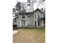 Gray two-story house with a black front door and landscaping at 980 Fox Chase Ln, Riverdale, GA 30296