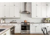 Modern kitchen with white cabinets, stainless steel appliances, and marble backsplash at 120 Clover Ct, Roswell, GA 30075