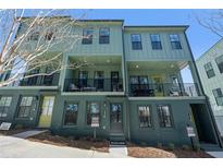 Three-story townhomes with modern design, featuring light green siding and yellow doors at 1413 Cozy Court # 261, Atlanta, GA 30315