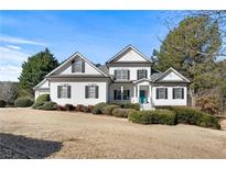 Two-story house with white siding, black shutters, and a teal front door at 164 Castlewood Rd, Tyrone, GA 30290