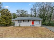 Charming ranch home with red front door and well-maintained lawn at 37 Delmoor Nw Ct, Atlanta, GA 30311