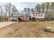 Brick ranch house with attached garage and landscaped yard at 2906 Forestside Ln, Atlanta, GA 30349