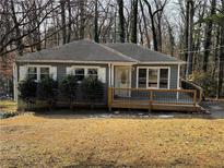 Gray house with new deck, surrounded by trees at 6070 Blackhawk Se Trl, Mableton, GA 30126