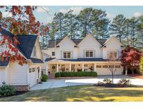 Two-story white farmhouse with large porch and attached garage at 981 Fairfield Dr, Marietta, GA 30068