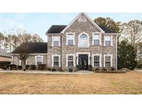 Two-story brick home with a large front yard and landscaping at 3111 Green Gate Se Way, Conyers, GA 30013
