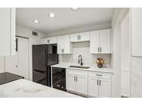 Bright kitchen with white cabinets, quartz countertops, black appliances, and stylish black hardware at 1608 Vicksburg Pl, Sandy Springs, GA 30350