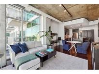 Bright living room with floor-to-ceiling windows and modern decor, perfect for relaxing and entertaining guests at 250 Pharr Rd # 1707, Atlanta, GA 30305