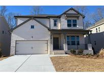 Two-story house with white brick exterior, gray accents, and a two-car garage at 31 Bennett Farm Dr, Loganville, GA 30052