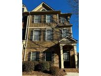Charming townhome featuring a brick facade and neutral siding with black shutters and a covered front entrance at 3857 Felton Hill Sw Rd # 9, Smyrna, GA 30082
