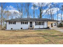 Charming single-story home features a well-maintained lawn, brick exterior and a convenient carport at 5774 Forest Dr, Acworth, GA 30102