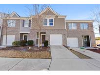 Two-story townhouse with brick and siding exterior at 1646 Larkspur Trl, Conyers, GA 30012